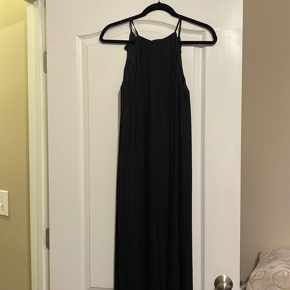 Pleated black jumpsuit with halter neckline